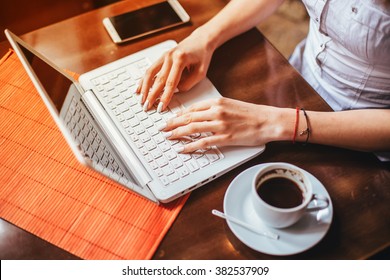 Typing Hands/ Woman Using Laptop In Coffee Shop