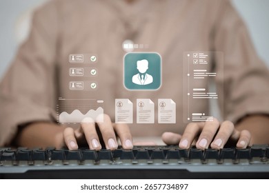 Typing on keyboard with digital interface for HR management, employee data, and profile review.
