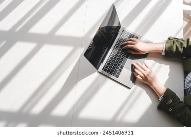 Typing on keyboard Working online on laptop computer On a white table at the office. Facebook chat. Web meeting. Blogger. Journalist writing an article. online job ideas