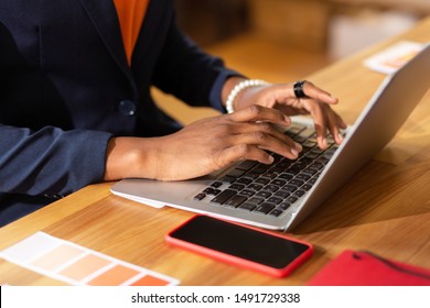 Typing on laptop. Close up of busy interior designer typing message for client on laptop - Powered by Shutterstock