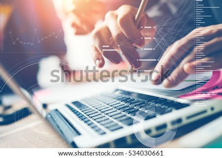 Typing on laptop close-up. Man working on computer. Business team in office. Meeting report in progress. Film effect, blurry background. Statistic graph overlay, icon innovation interface