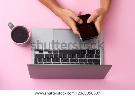 Typing text. Hand using gadgets, device on top view, blank screen with copyspace, minimalistic style. Technologies, modern, marketing. Negative space for ad. Coral color on background. Stylish, trendy