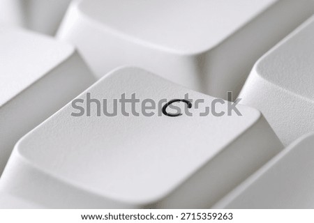 Typing and text input concept with a white C key