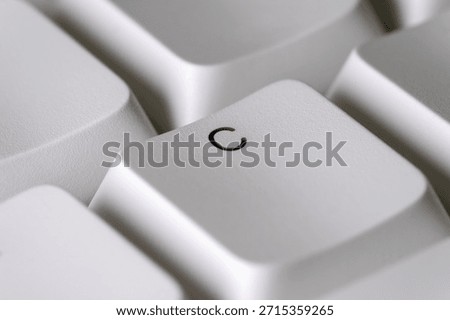 Typing and text input concept with a white C key