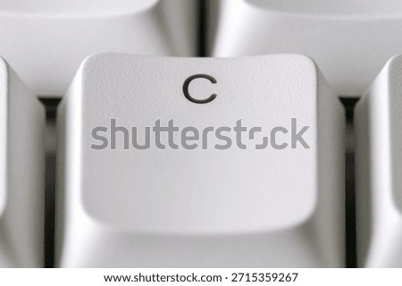 Typing and text input concept with a white C key