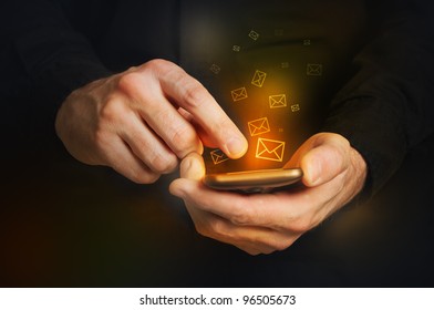 Typing Text Message On Smartphone. Focus On Hands And The Phone Device. Orange Envelopes As Incoming Or Outgoing Messages.