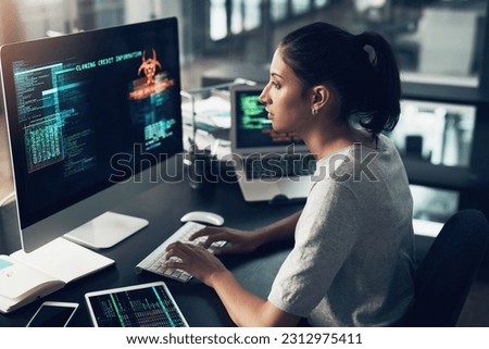 Typing, woman and hacker, computer programmer or coder hacking data. IT, focus and female developer, engineer or person programming, coding and writing software for phishing, cyber security or virus.