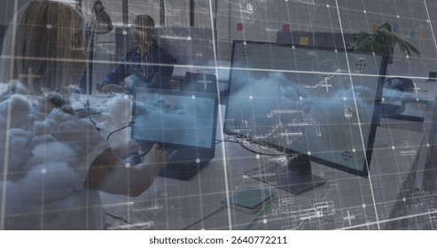 Typing woman at laptop and man working at dual monitors in office, with cloud computing graphics. Technology, collaboration, innovation, workspace, digital, enterprise, modern - Powered by Shutterstock - Get 15% off with code: PIKWIZARD15