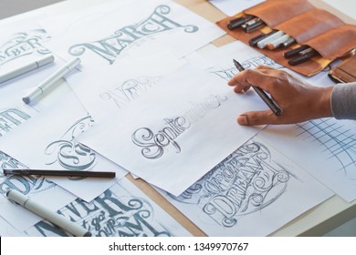 Typography Calligraphy artist designer drawing sketch writes letting spelled pen brush ink paper table artwork.Workplace design studio. - Shutterstock ID 1349970767