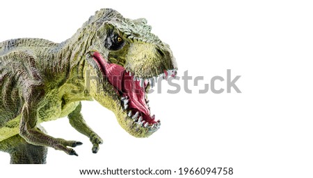 Tyrannosaurus Rex figurine isolated on white. Side view of a fierce T-Rex dinosaur. Tyrannosaurus was a bipedal carnivore with a massive skull. Exist before the Cretaceous-Paleogene extinction event.