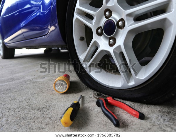 Tyre air pressure is leaking it needs to fix in a\
garage. In the photo has the tools for replacement but looks like\
ist is not enough.