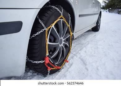 Tyre with chains, car in winter season on snow