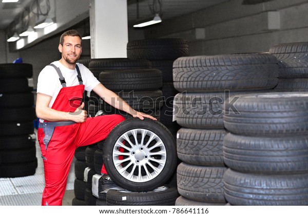 tyre
change on the car in a workshop by a mechanic
