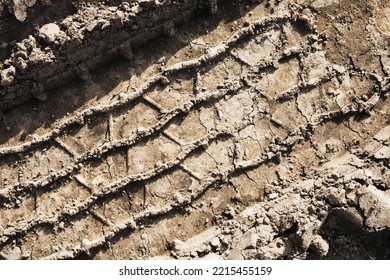 Tyre Mark Background. Tire Track Shape. Trail Lines On Dry Brown Sand Pattern. Road Construction Site Backdrop. Heavy Machinery Imprint. Dried Mud Vehicle Wheel Shape.