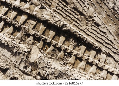 Tyre Mark Background. Tire Track Shape. Trail Lines On Dry Brown Sand Pattern. Road Construction Site Backdrop. Heavy Machinery Imprint. Dried Mud Vehicle Wheel Shape.