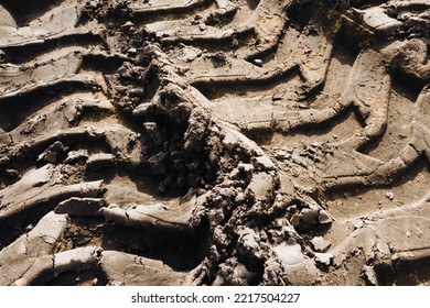 Tyre Mark Background. Tire Track Shape. Trail Lines On Dry Brown Sand Pattern. Road Construction Site Backdrop. Heavy Machinery Imprint. Dried Mud Vehicle Wheel Shape.