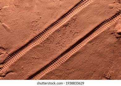 Tyre Pattern On The Reddish-orange Sandy Surface With Copy Space. Imitation Of The Traces Of The Rover On The Planet Mars. Top View