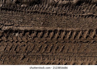 Tyre track on dirt sand or mud, Picture in retro or grunge tone. Car drive on sand. off road track. Track on grass field. Track in farm.