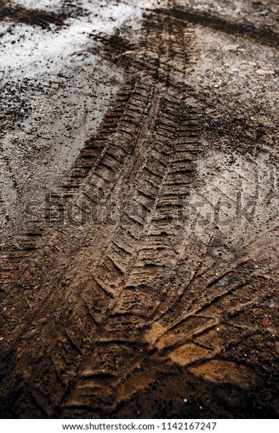 Tyre track on dirt sand or\
mud, Picture in retro or grunge tone. Car drive on sand. off road\
track.