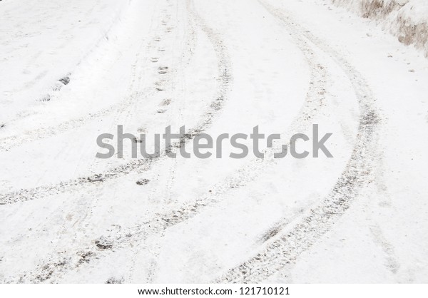 Tyre tracks and\
footsteps in a fresh snow