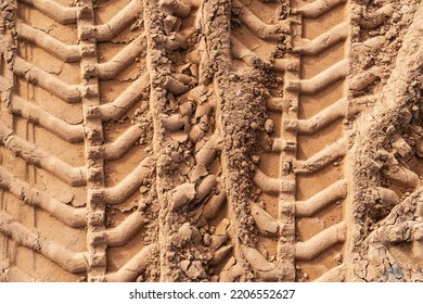 Tyre Tracks On Sand In Construction Site. Abstract Background And Pattern.