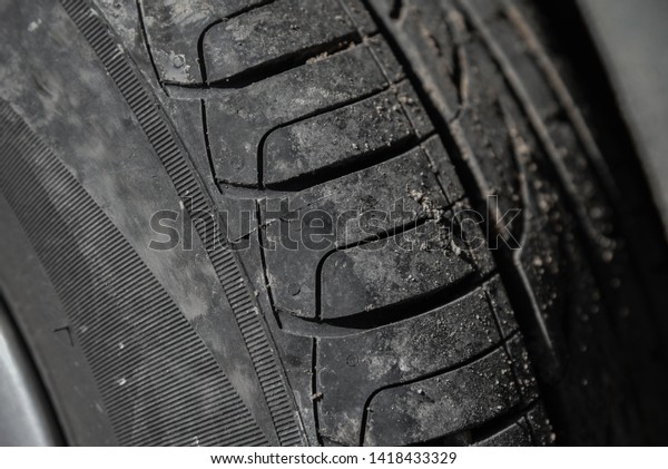 Tyres background. Car tyres close up. Close\
up view of car wheel. Transportation concept. Black color. Traffic\
jam. tire replacement.