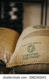 TYUMEN, RUSSIA - NOVEMBER 26, 2021: Bags Of Green Coffee Beans With Fair Trade Logo