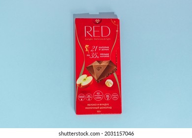 Tyumen, Russia-August 06, 2021: Red Milk Chocolate With Hazelnuts And Apple. The Swiss Company Chocolette Confectionary Latvia.