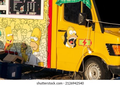 Tyumen, Russia-February 07, 2022: Simpsons On A Car, Cafe, Logos. By Matt Groening For The Fox Broadcasting Company