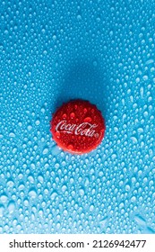 Tyumen, Russia-January 19, 2022: Coca Cola red cap of glass bottle. Droplets of water copy space