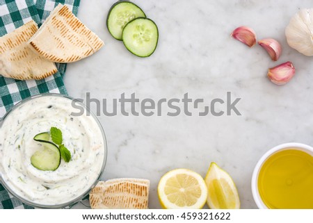 Similar – Tzatziki and pita bread on marble