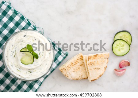 Similar – Tzatziki and pita bread on marble