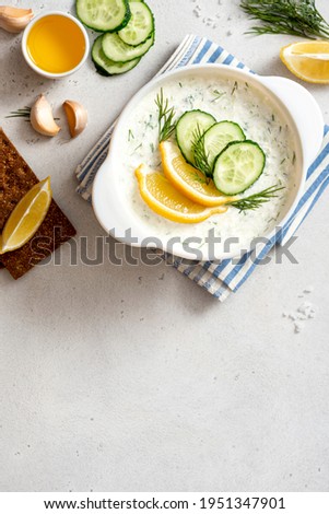 Similar – Tzatziki and pita bread on marble