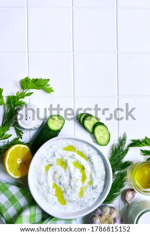 Similar – Tzatziki and pita bread on marble