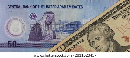 UAE 50 dirham banknote and US 10 dollar banknote close up