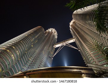 uala Lumpur, Malaysia - June 2018: Petronas Towers and Suria KLCC at night with beautiful lighting. The most famous skyscrapers of Kuala Lumpur and all of Malaysia. Night sky with highest buildings 
