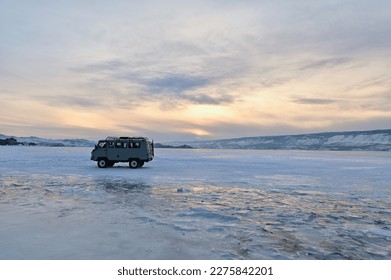 UAZ 452 or Bukhanka on Frozen Lake Baikal During Sunset