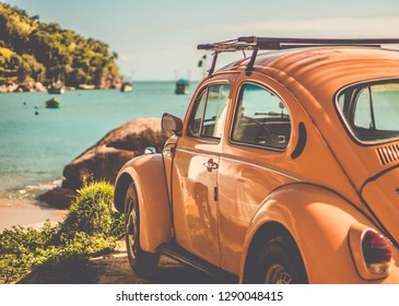 UBATUBA/SAO PAULO/BRAZIL - 09.09.2018: Volkswagen Beetle parking at the seaside. Car in front of the ocean landscape