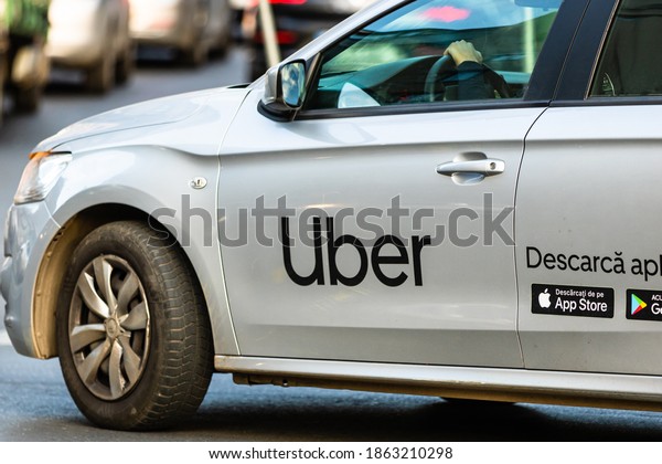 Uber car in traffic, modern city taxi\
service. Car pollution, traffic jam in the morning and evening in\
the capital city of Bucharest, Romania,\
2020