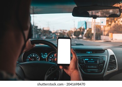 uber driver showing the phone while driving wearing a facemask