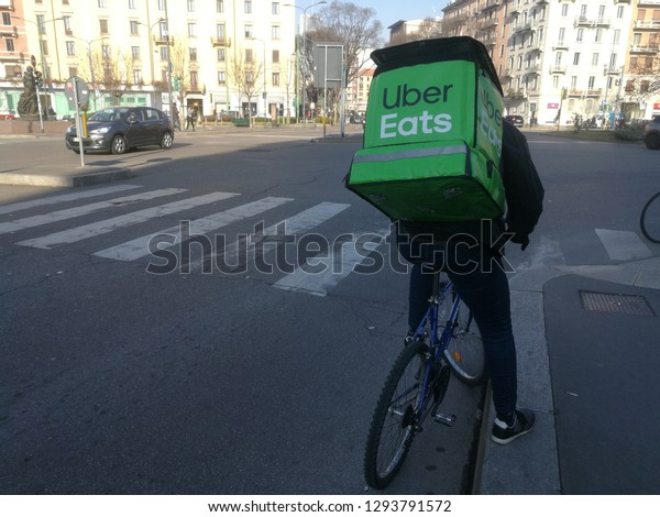 Uber Eats Biker Rider for\
Food Delivery Service in the City Center View in Milan,Italy\
January 2019