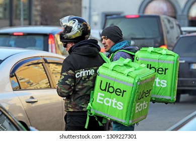 uber eats couriers on a road in Kiev, Ukraine, 7 February 2019.