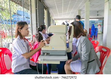 Ubon Ratchathani, Thailand - October 7, 2017 : The Female Optictian Examining A Cute Young Nurse's Eye In Community Service Event.