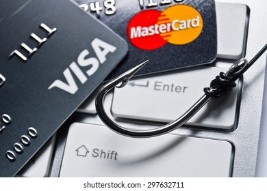 Ubonratchathani, Thailand- July 18, 2015 : Close up of VISA and Mastercard credit card on white computer keyboard with a fish hook