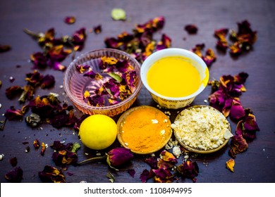 Ubtan Or Face Pack Of Lemon And Gram Flour With Rose Water With Some Rosa Leaves On Wooden Surface.