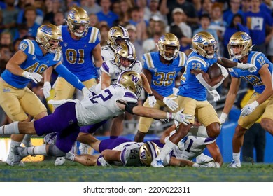 UCLA Running Back Keegan Jones (22) Runs The Ball Fighting Off Pressure From The Washington During An NCAA College Football Game Friday, Sept. 30, 2022, In Pasadena, Calif. 