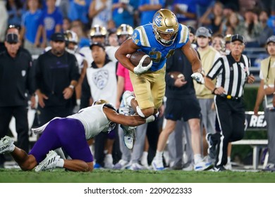 UCLA Running Back Zach Charbonnet (24) Is Tackled By Washington Safety Alex Cook (5) During An NCAA College Football Game Friday, Sept. 30, 2022, In Pasadena, Calif. 