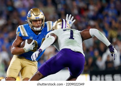 UCLA Running Back Zach Charbonnet (24) Escapes A Tackle-attempt By Washington Linebacker Dominique Hampton (7) During An NCAA College Football Game Friday, Sept. 30, 2022, In Pasadena, Calif. 