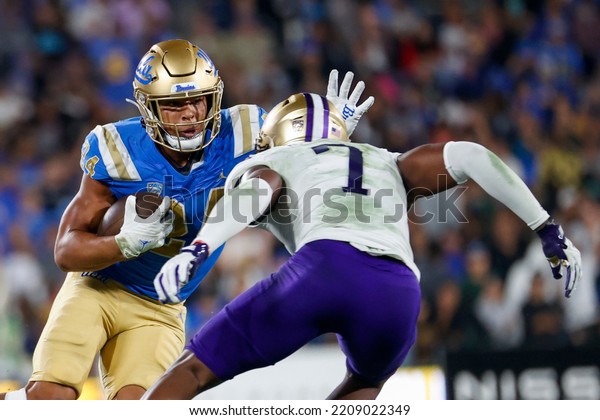UCLA running back Zach Charbonnet (24) escapes a\
tackle-attempt by Washington linebacker Dominique Hampton (7)\
during an NCAA college football game Friday, Sept. 30, 2022, in\
Pasadena, Calif. 