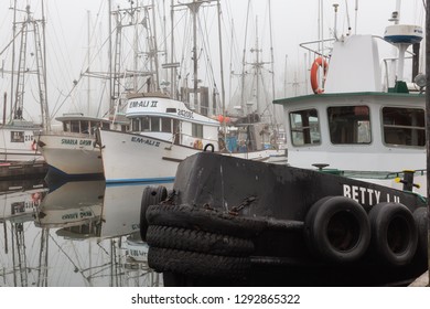 Ucluelet, Vancouver Island, BC, Canada - August 22, 2018: Fishing boats at a marina during a smoky and vibrant morning sunrise. - Shutterstock ID 1292865322